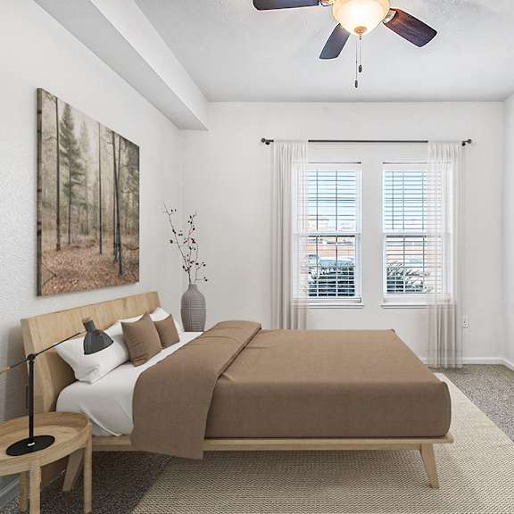 Thumbnail 12 of 13 A bedroom with a ceiling fan and two windows at Lynbrook Apartments and Townhomes, Elkhorn, NE, 68022