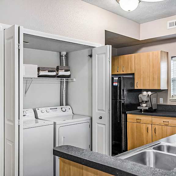 Thumbnail 9 of 13 An end kitchen with a window and washer and dryer at Lynbrook Apartments and Townhomes, Elkhorn, NE, 68022