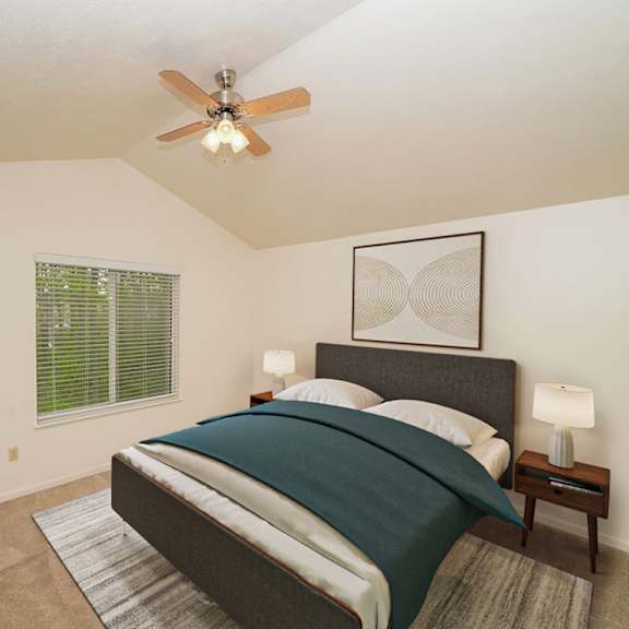 Thumbnail 11 of 15 A master bedroom with a cathedral ceiling and ceiling fan at Lynbrook Apartments and Townhomes, Nebraska