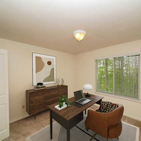 Thumbnail 15 of 15 A bedroom with a brown desk with a laptop at Lynbrook Apartments and Townhomes, Elkhorn, 68022