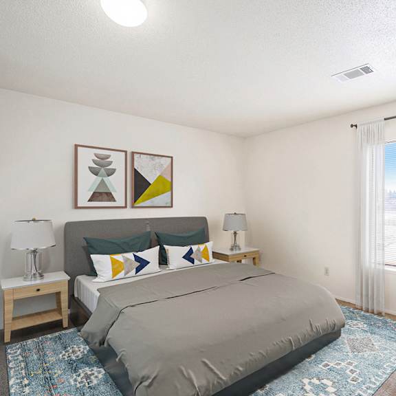Thumbnail 6 of 8 A bedroom with a large window and a bed at Madeira Apartments in Kalamazoo, MI 49001