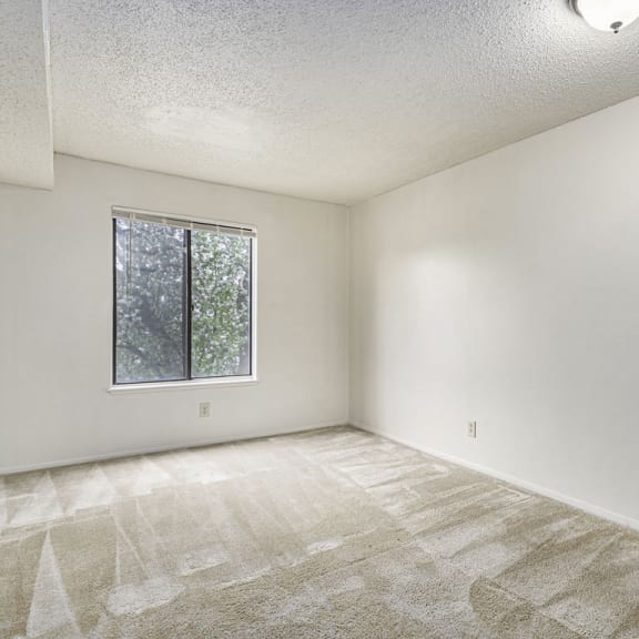 Thumbnail 7 of 8 an empty living room with a window at Madeira Apartments, Kalamazoo, 49001