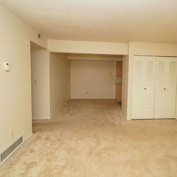 Thumbnail 4 of 9 the living room and dining room of an empty house at Madeira Apartments, Kalamazoo, 49001
