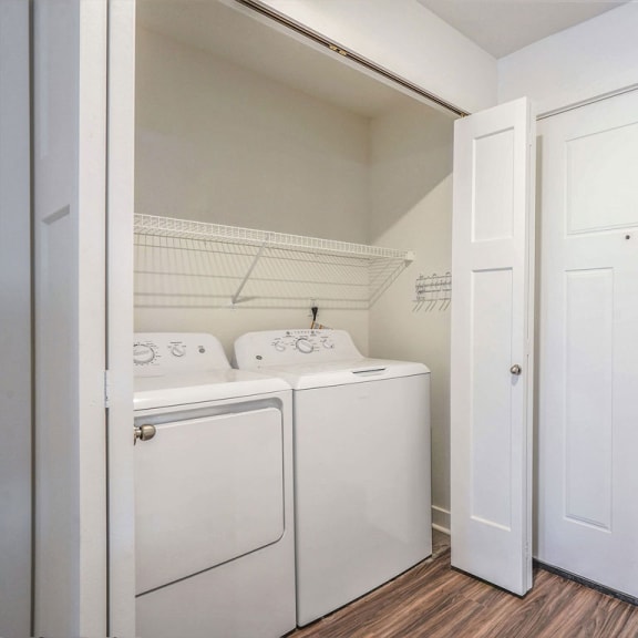 Thumbnail 3 of 9 a laundry room with a washer and dryer and a white door at Meadowbrooke Apartment Homes, Grand Rapids, 49512