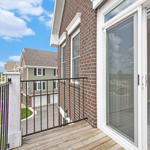 Thumbnail 4 of 11 a sliding glass door in a home with a deck at Meadowbrooke Apartment Homes, Grand Rapids, MI, 49512