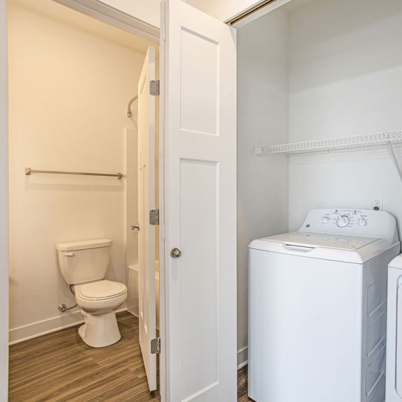 Thumbnail 7 of 11 a washer and dryer in a room with a toilet at Meadowbrooke Apartment Homes, Grand Rapids