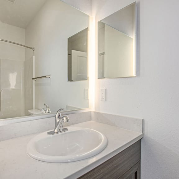 Thumbnail 8 of 11 a bathroom with a sink and a mirror at Meadowbrooke Apartment Homes, Grand Rapids, Michigan