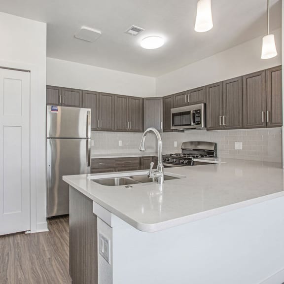Thumbnail 5 of 11 a kitchen with a sink and a refrigerator at Meadowbrooke Apartment Homes, Grand Rapids, 49512