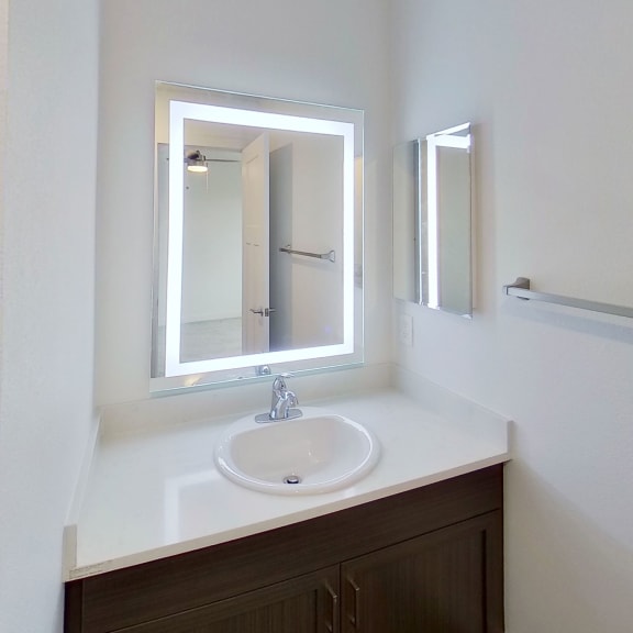 Thumbnail 10 of 11 a bathroom with a sink and a mirror at Meadowbrooke Apartment Homes, Grand Rapids, Michigan
