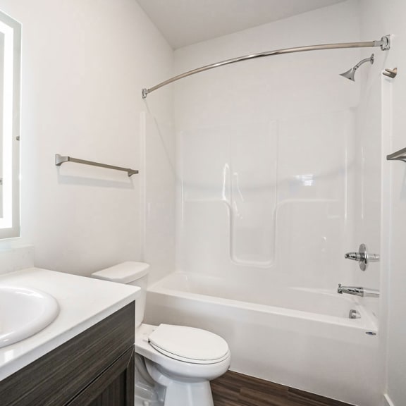 Thumbnail 7 of 11 a bathroom with a sink toilet and a shower at Meadowbrooke Apartment Homes, Michigan, 49512