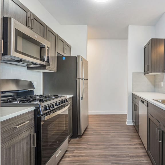 Thumbnail 5 of 9 a kitchen with stainless steel appliances and a sink at Meadowbrooke Apartment Homes, Grand Rapids, MI, 49512