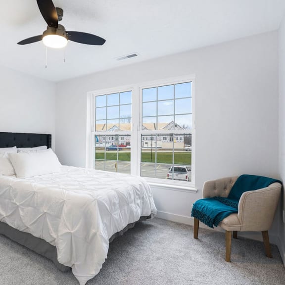 Thumbnail 8 of 11 a bedroom with a bed and a ceiling fan at Meadowbrooke Apartment Homes, Michigan, 49512