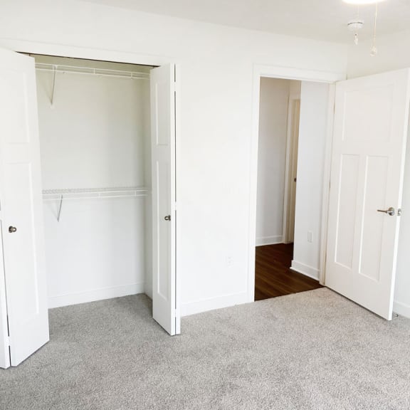 Thumbnail 9 of 9 an empty bedroom with white closet doors and a carpet at Meadowbrooke Apartment Homes, Grand Rapids
