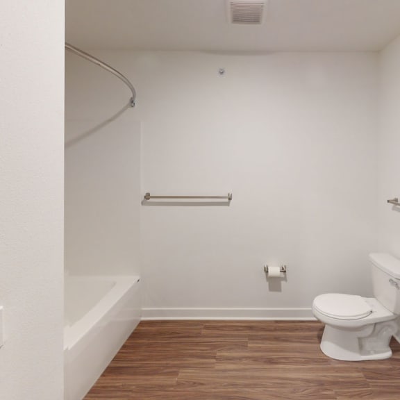 Thumbnail 7 of 10 a bathroom with a toilet and a sink and a bath tub at Meadowbrooke Apartment Homes, Grand Rapids, 49512