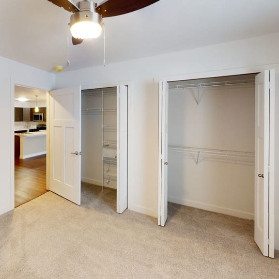 Thumbnail 10 of 10 a bedroom with a closet and a ceiling fan at Meadowbrooke Apartment Homes, Grand Rapids, Michigan