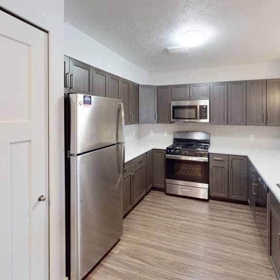 Thumbnail 4 of 10 a kitchen with stainless steel appliances and wooden cabinets at Meadowbrooke Apartment Homes, Grand Rapids, 49512
