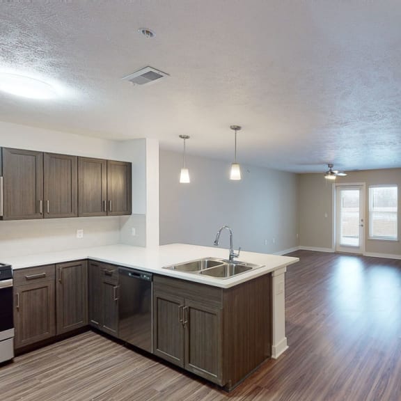 Thumbnail 3 of 10 an empty kitchen and living room with wood flooring and at Meadowbrooke Apartment Homes, Grand Rapids, MI