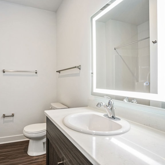 Thumbnail 12 of 12 a bathroom with a sink and a toilet and a mirror at Meadowbrooke Apartment Homes, Grand Rapids, MI, 49512
