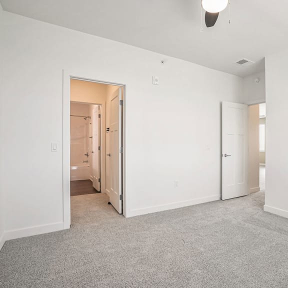 Thumbnail 11 of 12 an empty living room with white walls and carpet at Meadowbrooke Apartment Homes, Grand Rapids, 49512