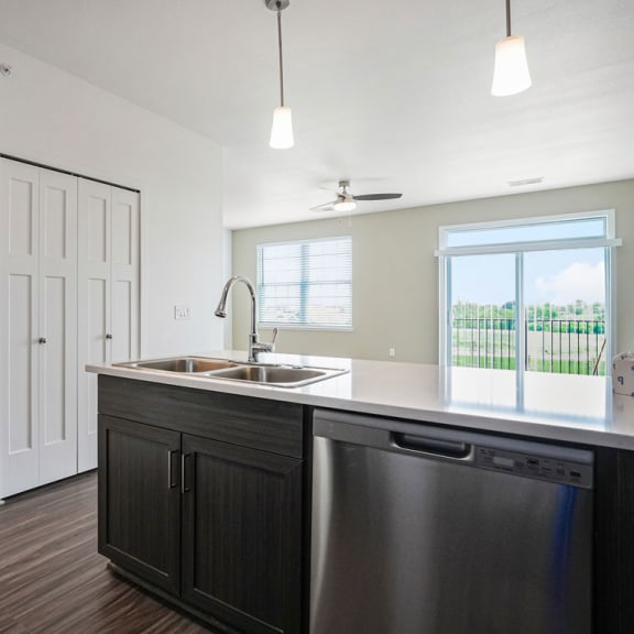 Thumbnail 5 of 12 an empty kitchen with a sink and a window at Meadowbrooke Apartment Homes, Michigan, 49512