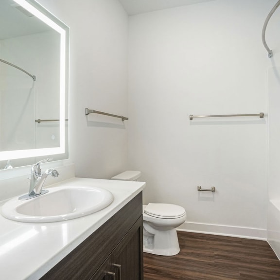 Thumbnail 7 of 11 a bathroom with a sink toilet and a mirror at Meadowbrooke Apartment Homes, Grand Rapids