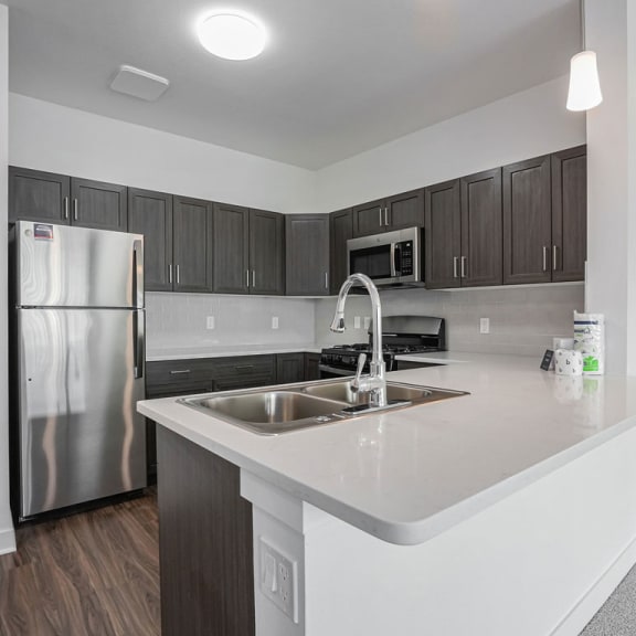 Thumbnail 5 of 11 a kitchen with a sink and a refrigerator at Meadowbrooke Apartment Homes, Grand Rapids, MI