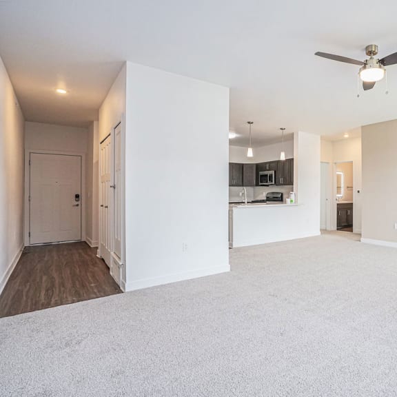 Thumbnail 4 of 11 an empty living room with a ceiling fan at Meadowbrooke Apartment Homes, Grand Rapids