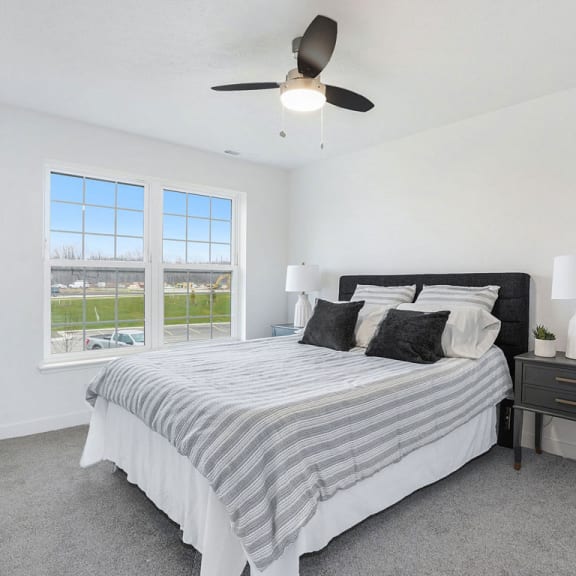 Thumbnail 8 of 8 a bedroom with a bed and a ceiling fan at Meadowbrooke Apartment Homes, Grand Rapids, 49512