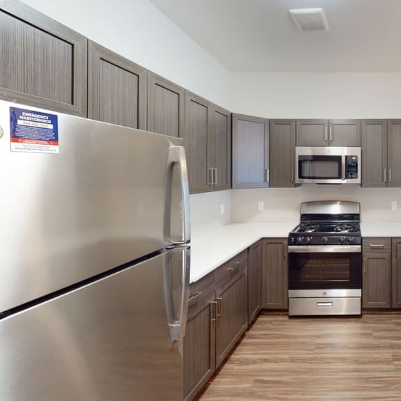 Thumbnail 5 of 8 a kitchen with stainless steel appliances and wooden cabinets at Meadowbrooke Apartment Homes, Grand Rapids
