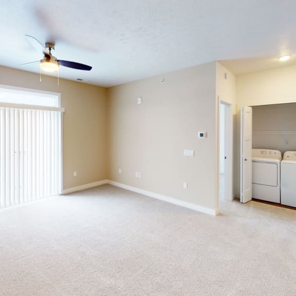 Thumbnail 6 of 8 an empty living room with a closet and a laundry room at Meadowbrooke Apartment Homes, Grand Rapids, MI, 49512