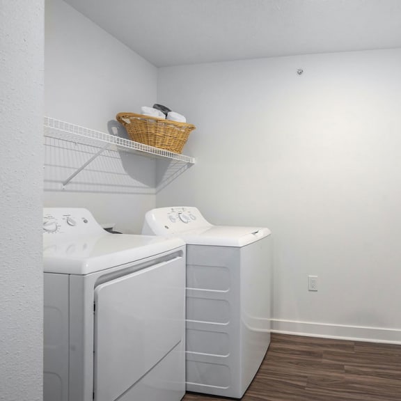 Thumbnail 8 of 12 a laundry room with a washer and dryer and a white closet at Meadowbrooke Apartment Homes, Michigan
