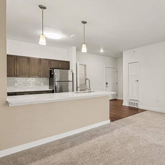 Thumbnail 9 of 15 A kitchen with breakfast bar at Meadowbrooke Apartment Homes in Grand Rapids, MI 49512