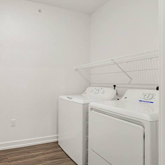 Thumbnail 11 of 15 A laundry room with a washer and dryer at Meadowbrooke Apartment Homes in Grand Rapids, MI 49512
