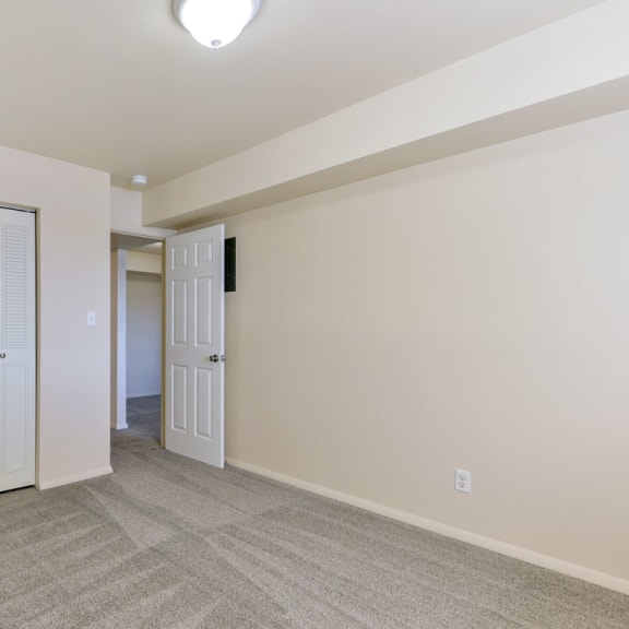 Thumbnail 7 of 8 a living room with white doors and a door to a hallway at Old Monterey Apartments, Missouri