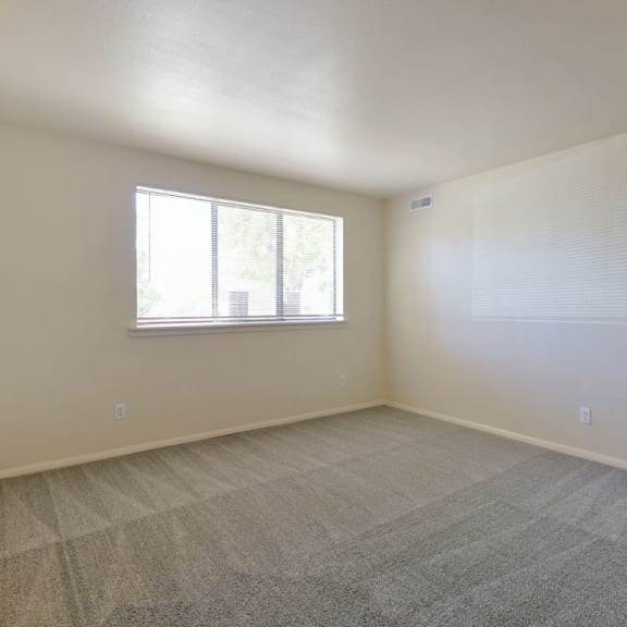 Thumbnail 3 of 8 an empty living room with a window and carpet at Old Monterey Apartments, Springfield, MO, 65807
