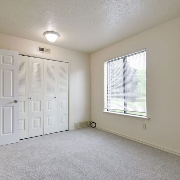Thumbnail 9 of 11 an empty room with a door and a window at Old Monterey Apartments, Springfield, MO, 65807