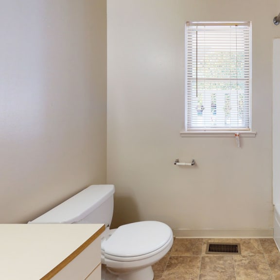 Thumbnail 6 of 9 a bathroom with a toilet and a tub and a sink at Mount Royal Townhomes, Kalamazoo, MI