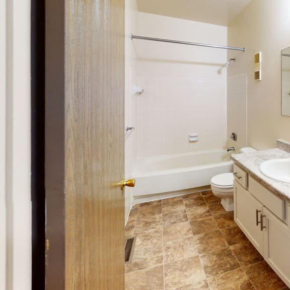 Thumbnail 5 of 7 a bathroom with a sink toilet and a shower at Mount Royal Townhomes, Kalamazoo, Michigan