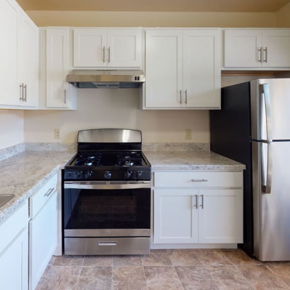 Thumbnail 3 of 7 a kitchen with stainless steel appliances and white cabinets at Mount Royal Townhomes, Kalamazoo, MI