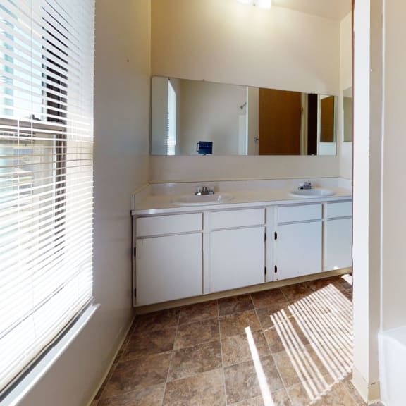 Thumbnail 9 of 13 a bathroom with a tub and a sink and a mirror at Mount Royal Townhomes, Michigan