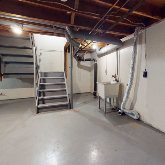 Thumbnail 13 of 13 an empty basement with a staircase and a sink at Mount Royal Townhomes, Kalamazoo, 49009