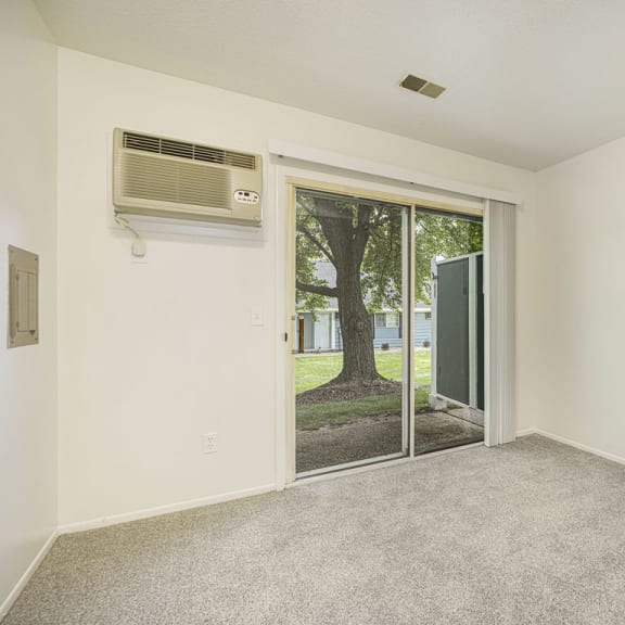 Thumbnail 10 of 11 Bedroom with a slider to semi private patio at Newport Village Apartments, Portage, MI