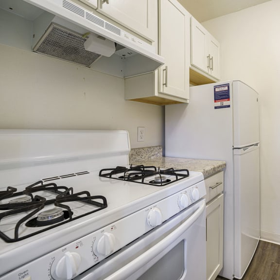 Thumbnail 6 of 11 a kitchen with hard-surface flooring at Newport Village Apartments in Portage, MI