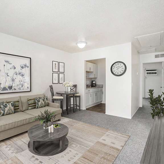 Thumbnail 4 of 13 living and dining rooms to a kitchen with hard surface flooring at Newport Village Apartments, Portage, MI