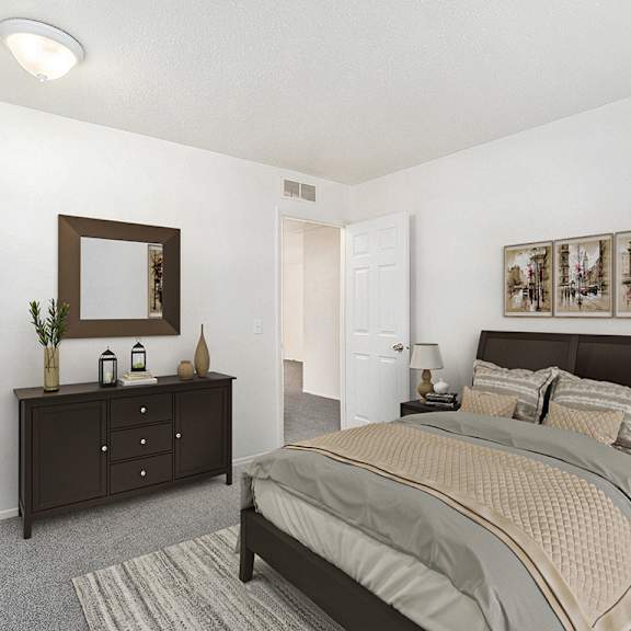 Thumbnail 10 of 13 A bedroom with a bed, dresser, and mirror at Newport Village Apartments, Portage, MI