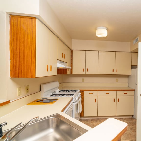 Thumbnail 8 of 14 an empty kitchen with white appliances and white cabinets at North Pointe Apartments, Indiana, 46514