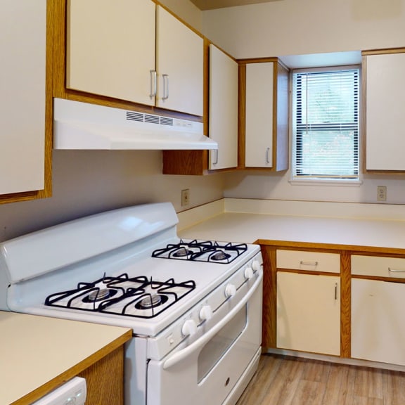 Thumbnail 5 of 5 an empty kitchen with a stove and refrigerator at North Pointe Apartments, Elkhart, IN