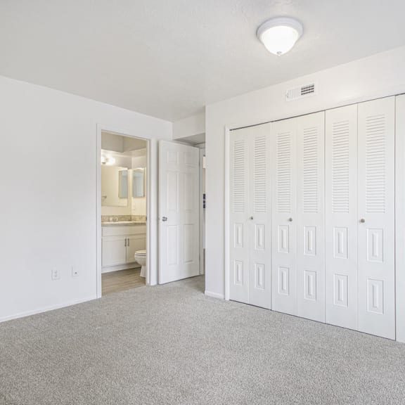 Thumbnail 16 of 17 master bedroom with a large closet and a bathroom at North Pointe Apartments in Elkhart, IN