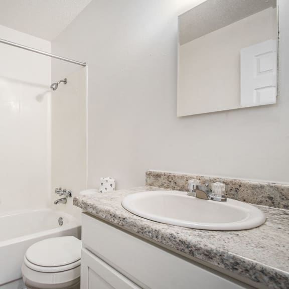 Thumbnail 14 of 19 a renovated bathroom with a sink toilet and a bath tub at Normandy Village Apartments, Michigan City, 46360
