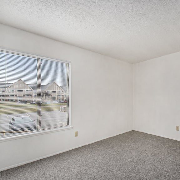 Thumbnail 19 of 19 bedroom with a large window and carpeting at Normandy Village Apartments, Indiana, 46360